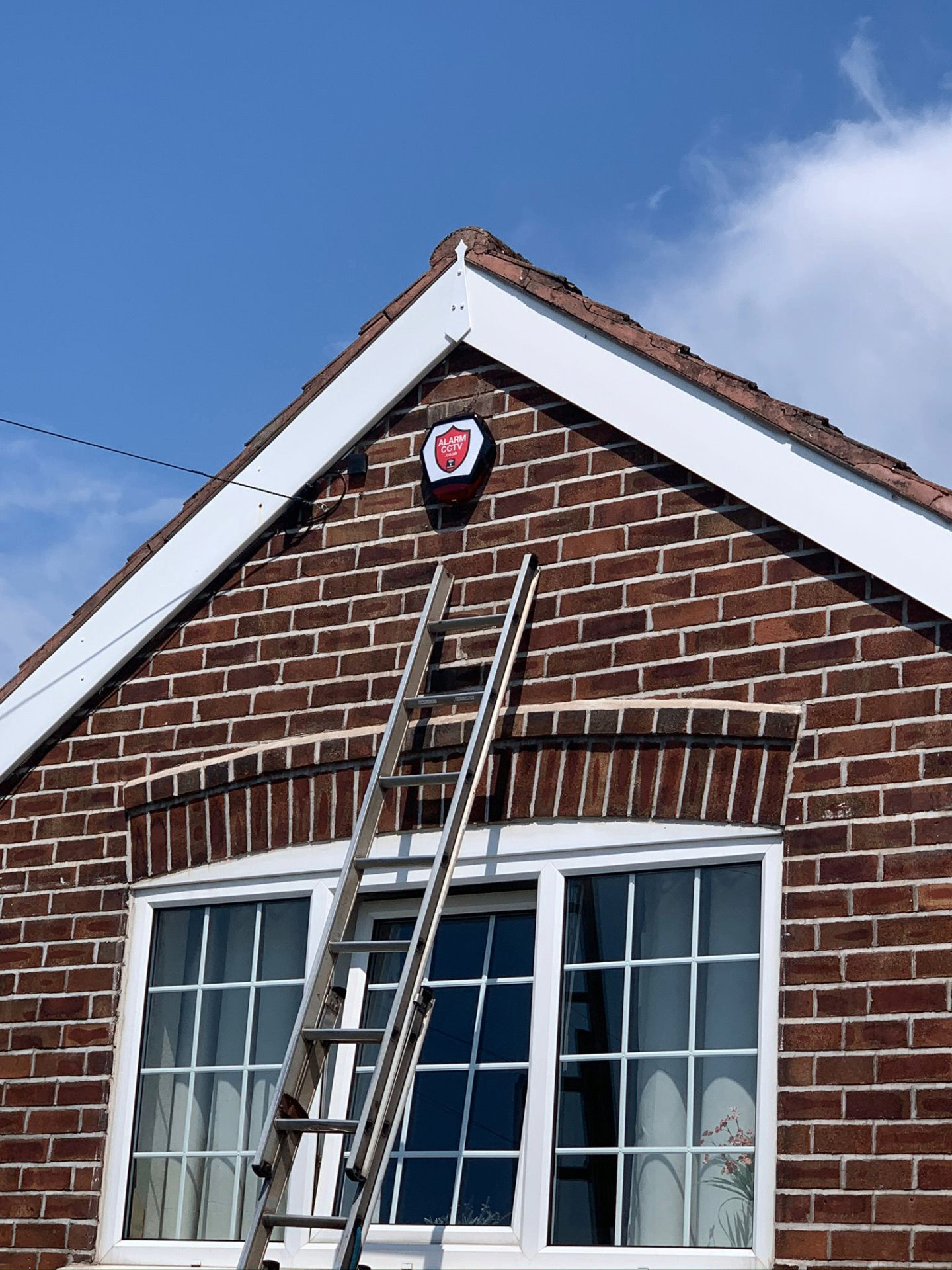 AlarmCCTV engineer fitting an alarm system at a home in the North West